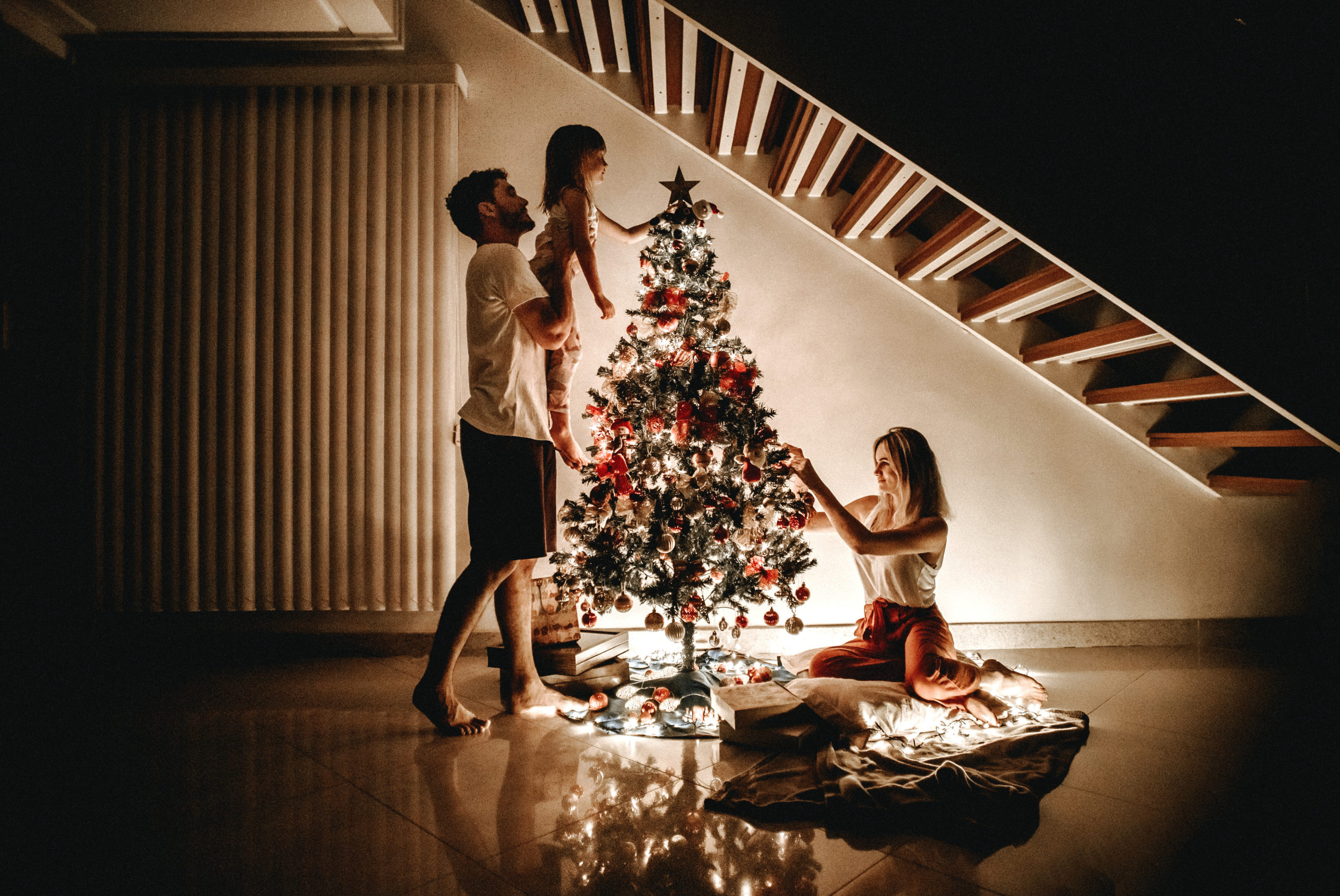 Family decorating their christmas tree